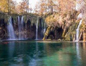 A beautiful landscape shot of a scenic lake with waterfalls flowing into it in Plitvice, Croatia