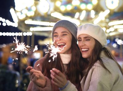 Best friends with sparklers on Christmas market