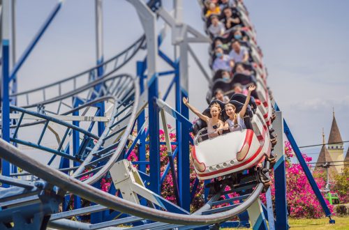 Happy friends in amusement park on a summer day.