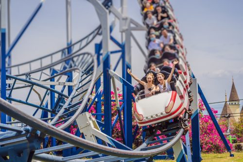Happy friends in amusement park on a summer day.