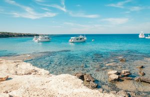 Tourist boats are mooring at Blue lagoon at Akamas peninsula on Cyprus